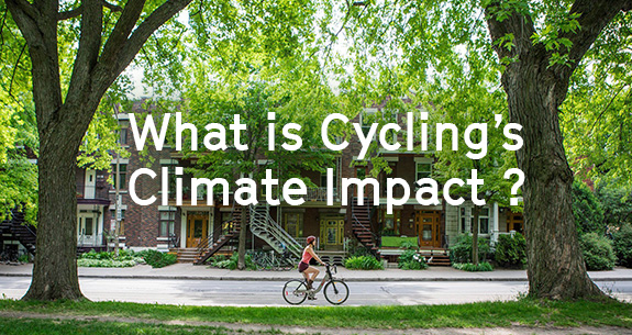 Girl on a Bixi bike in Montreal in a street full or trees